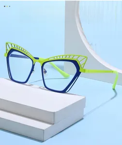 Detail view of cat eye glasses frame with green and blue geometric hollow texture