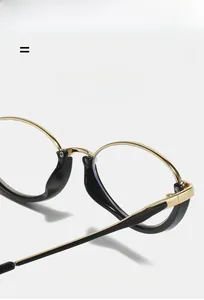 Detail of lightweight golden metal eyeglass frame with durable black acetate temple tips