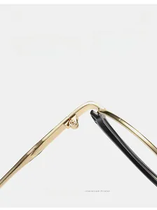 Close-up of durable golden metal hinges and black temples on cat eye sunglasses