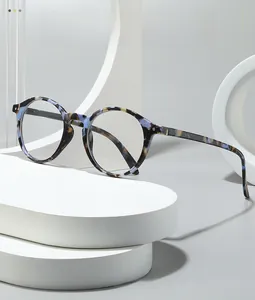 Detail of retro round glasses frame with marble tortoise pattern and metal studs