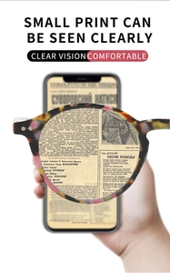 Close-up of tortoise shell round reading glasses showing sharp focus on text