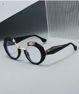 Detailed view of black geometric eyeglass frames with gold bridge and texture material