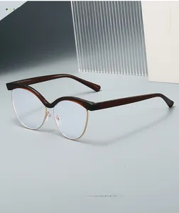 Detailed view of cat-eye glasses with brown tortoiseshell upper and gold metal frame