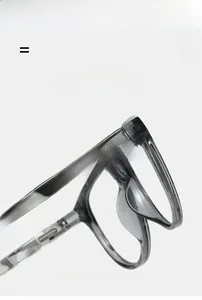 Detail of square gray eyeglass frames showing flexible geometric pattern temples and texture