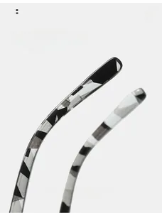 Detailed macro view of square glasses featuring printed camouflage patterned temple arms