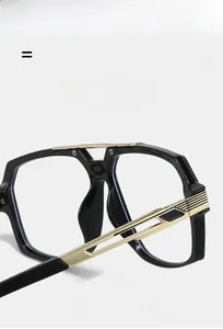 Detail of metal hinge and golden temples on fashionable double-bridge black eyeglass frames