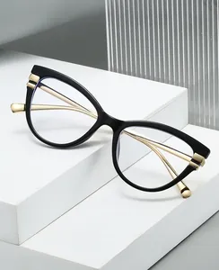 Detail of blue light blocking cat-eye glasses with black frames and gold metal temples