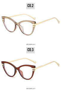 Detail view of cat eye glasses in champagne and red-brown with golden metal temples