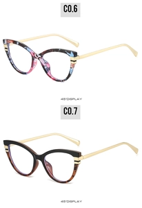 Detail view of cat-eye glasses frames with tortoiseshell patterns and gold metal hinges