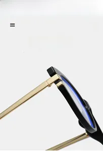Detail of blue light blocking cat eye glasses with gold metal hinges and black frame