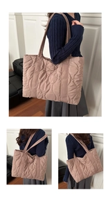Detailed wave quilted texture and satin finish on light pink down tote shoulder bag
