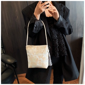 Detail of elegant landscape jacquard tote bag with grey long tassel charm decoration