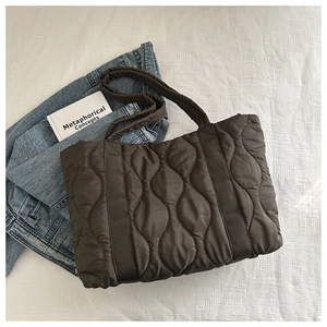 Detailed top view of dark coffee quilted nylon tote bag with wavy stitching patterns