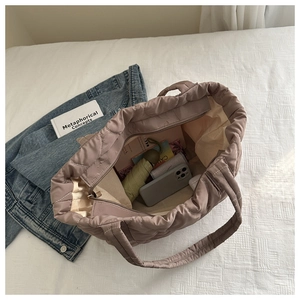 Quilted tote bag in dusty rose featuring large capacity for commuting and daily essentials