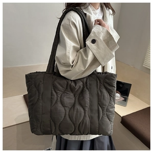 Quilted olive green tote bag with wavy stitching for autumn winter casual commuters