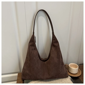 Detailed close-up of dark brown suede hobo bag with matte texture and minimalist design
