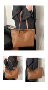 Detail of a brown leather tote bag showing large capacity and smooth curved stitching