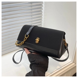 Detail of black matte leather shoulder bag with gold twist lock and chain strap