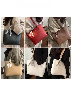 Detail view of large tote bags with silk scarves in black, red, brown, and khaki colors