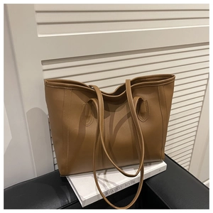 Detail of caramel brown leather tote bag showing fine stitching and premium texture