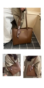 Detail of dark brown leather tote bag with geometric print silk scarf and long handles