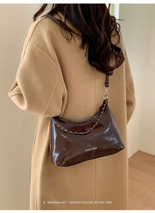Detail of dark brown patent leather shoulder bag with chain and Fashion & Bags lettering