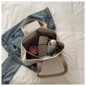 Spacious interior of linen tote bag showing umbrella and books with magnetic closure