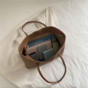 Brown faux leather tote bag showing spacious interior with tablet and daily essentials