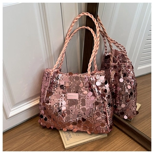 Detail of pink sequin tote bag showing woven satin handle and fashion brand label
