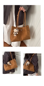 Caramel suede tote bag detail featuring slender straps and a leopard-print plush charm