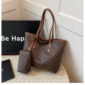 Détail d'un grand sac cabas marron à motifs floraux et d'une petite pochette assortie