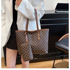 Détail d'un ensemble de sacs cabas marron foncé à motif géométrique avec une petite pochette