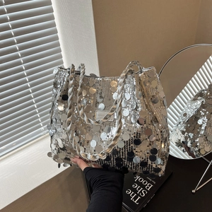 Silver sequin tote bag with woven handle and fashion label for summer party look