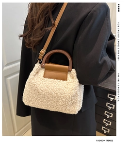 Detail of white plush crossbody bag with brown leather flap and stylish wood texture handle