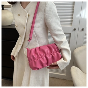 Detail showing the pink pleated texture and silver hardware of the chic hobo bag