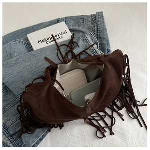Top view of deep brown suede hobo bag with fringe details showing large interior capacity