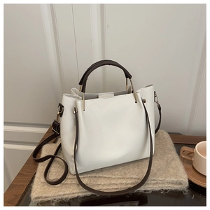 Detailed side view of white lychee pattern leather tote bag with brown handles and hardware