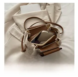Interior view of fuzzy cream crossbody bag showing main compartment and zipper pocket