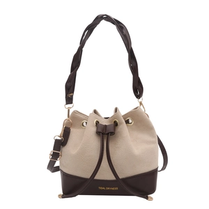 Chic two-tone bucket bag in beige suede and brown leather with woven handle