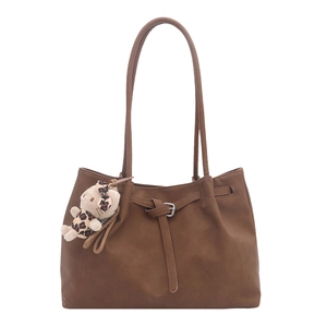 Retro large capacity brown tote bag with pleated detail and plush pendant on white background