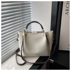 Modern creamy white lychee grain leather tote bag with dark brown handles and gold hardware