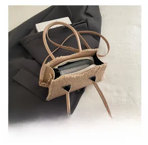 Detail view of the spacious inner compartment and plush trim of this khaki tote bag