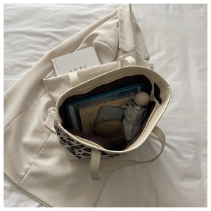 Detail view of large leopard print tote bag interior showing ample storage space