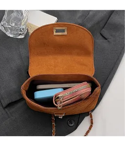 Top view of brown suede bucket bag interior showing phone, wallet and power bank space