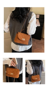 Macro detail of brown suede quilted crossbody bag with metal chain and turn-lock closure