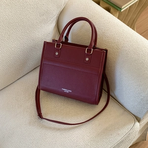 Fashionable dark red leather tote bag with lychee texture and adjustable shoulder strap