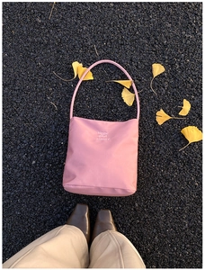 Pink underarm bag with Hope and Future embroidery on autumn leaves road
