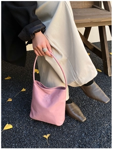 Pink nylon tote bag with hope and future embroidery shown in an outdoor autumn setting