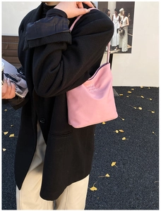 Pink nylon tote bag with hope and future slogan shown on model in outdoor casual setting