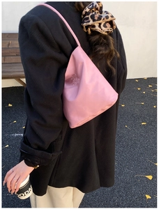Detailed shot of pink triangle shoulder bag with embossed Hope and future text
